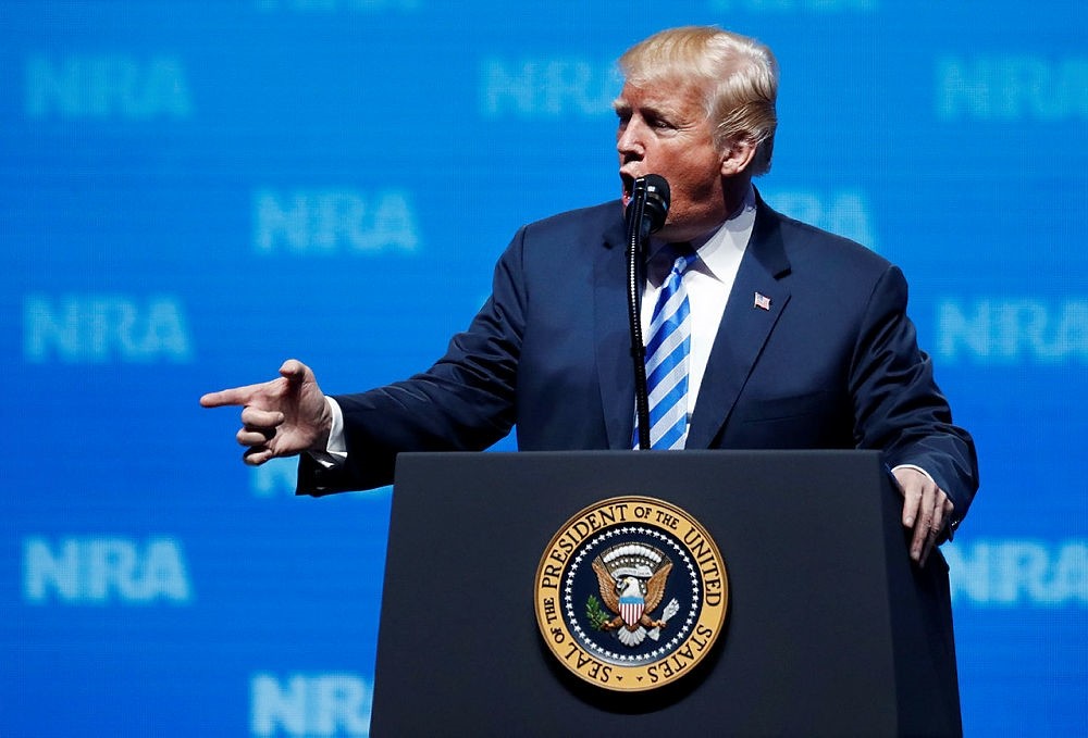 U.S. President Donald Trump pretends to shoot with his hand while speaking about the Paris shootings to the NRA Forum at the annual meetings inside the Kay Bailey Hutchison Convention Center in Dallas, Texas, U.S., May 4, 2018. (EPA Photo)