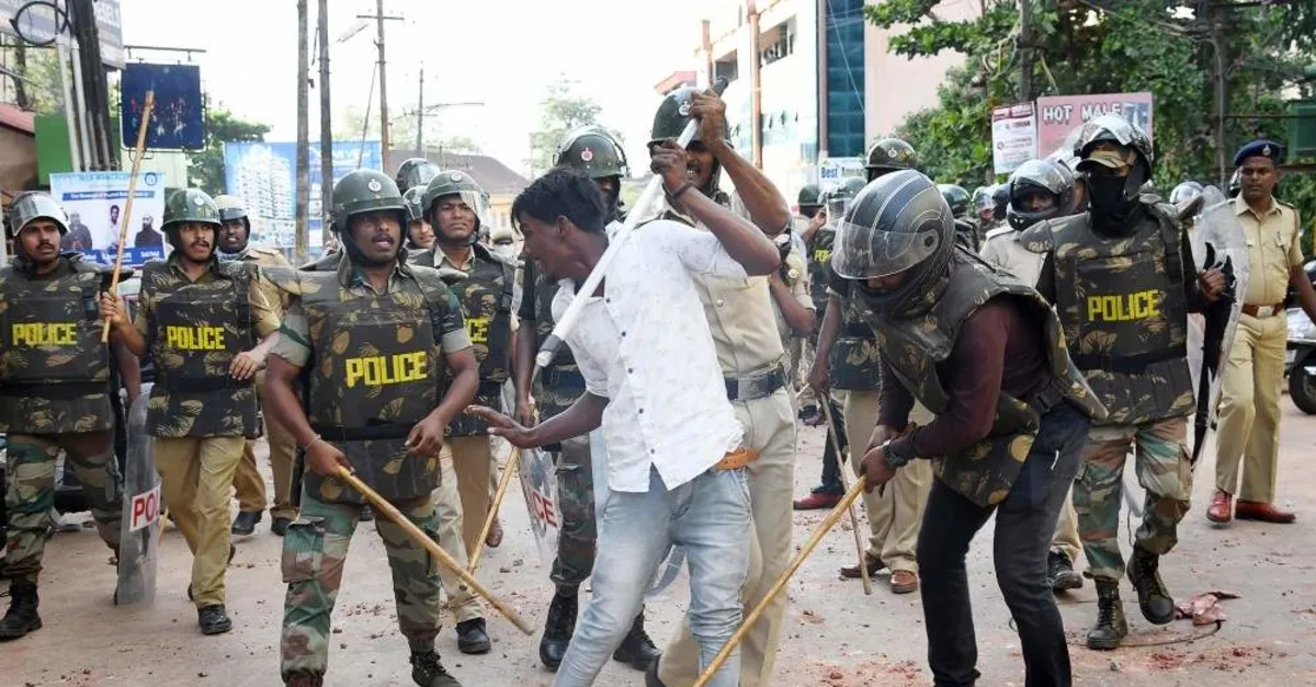 Policemen with sticks locally known as ,lathi, beat a protester during a demonstration against India's new citizenship law, Mangalore, Dec. 19, 2019 (AFP Photo)