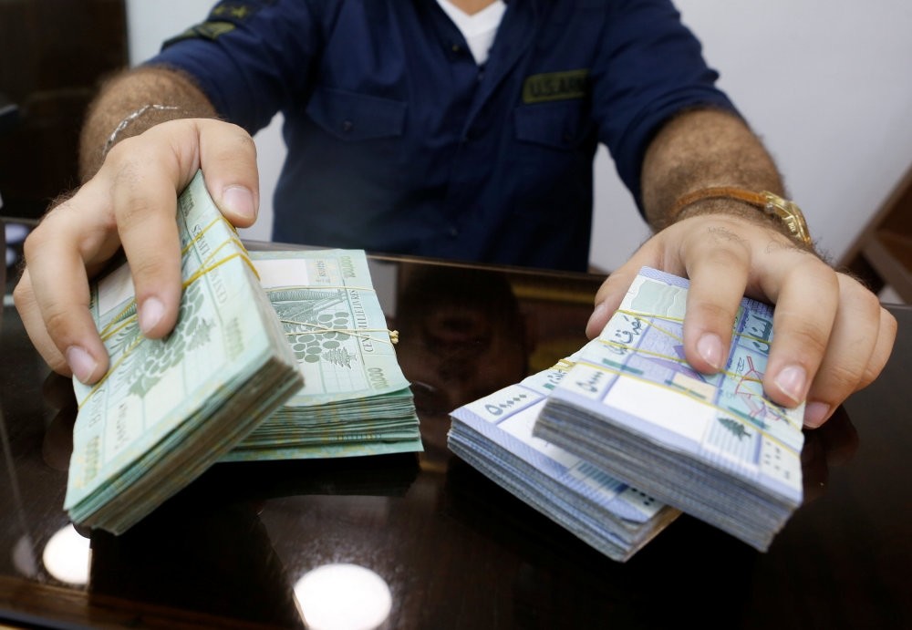 A money exchange vendor displays Lebanese pound banknotes at his shop in Beirut, Aug. 16.