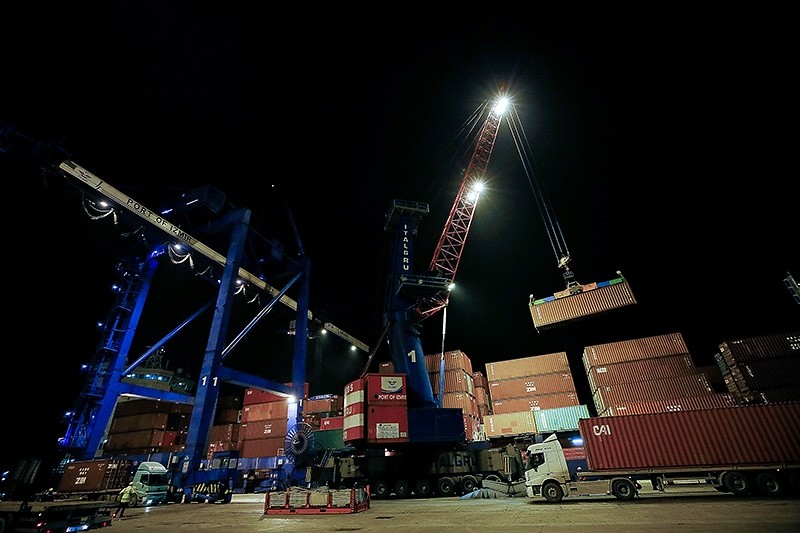 This file photo dated Dec. 31, 2018, shows container being loaded onto a ship on New Year's Eve in western Turkey's the Port of Izmir, which remained open late in the night due to increased demand from exporters. (AA Photo)
