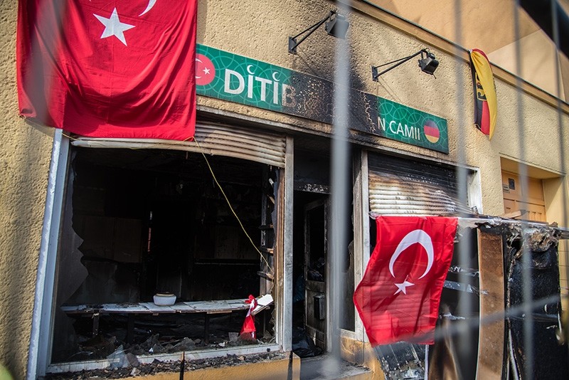 Turkish and German flags are seen on March 16 in front of the Koca Sinan Mosque that was set ablaze on March 11 by PKK supporters. (Sabah File Photo)
