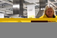 IKEA employees stand during a minute of silence in honor of Ingvar Kamprad, the founder of the Swedish furniture giant IKEA, Barkaby, near Stockholm.