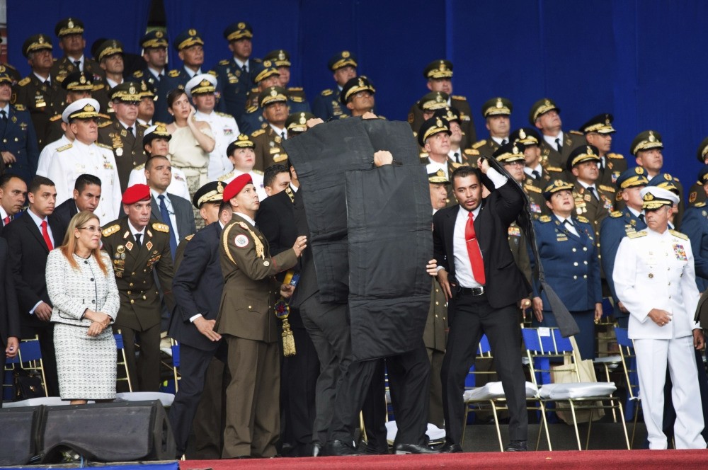 Security personnel surround Venezuela's President Nicolas Maduro after an assassination attempt made by drones armed with explosives against the president as he gave a speech in Caracas, Aug. 4.