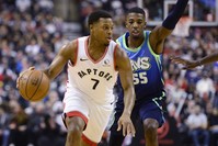 Toronto Raptors' Kyle Lowry (7) dribbles past Dallas Mavericks' Delon Wright (55), Toronto, Dec. 22, 2019. (AP Photo) 