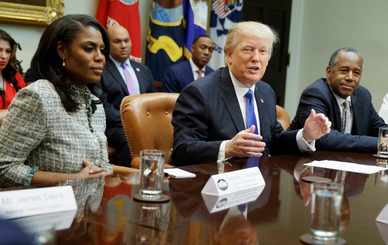 President Donal Trump (C) and White House staffer Omarosa Manigault Newman (L)  during a meeting on African American History Month (AP Photo)