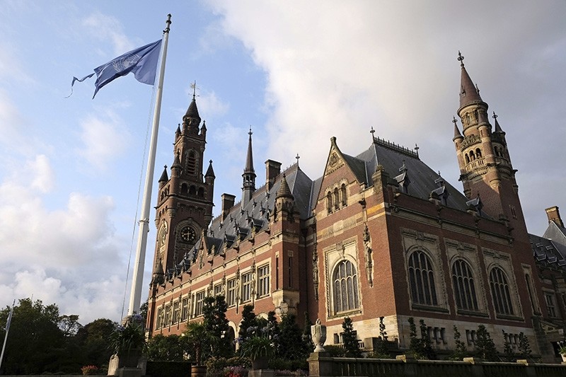 A United Nations flag flutters in the wind next to the International Court of Justice in the Hague, the Netherlands, Monday Aug. 27, 2018. (AP Photo)