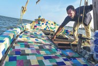The dhow made from recycled plastic floats during its official voyage launch at Lamu Island off northern coast of Kenya, on Jan. 23, 2019.
