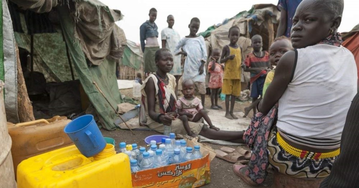 Unidentified people prepare plastic containers to collect water in a refugee camp, Juba, South Sudan, Feb. 28, 2012. (Vlad Karavaev/ iStock)