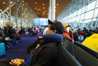 Passengers wearing protective facemasks amid concerns of the COVID-19 coronavirus outbreak wait to board their plane at Kuala Lumpur International Airport in Sepang on February 19, 2020. (AFP Photo)