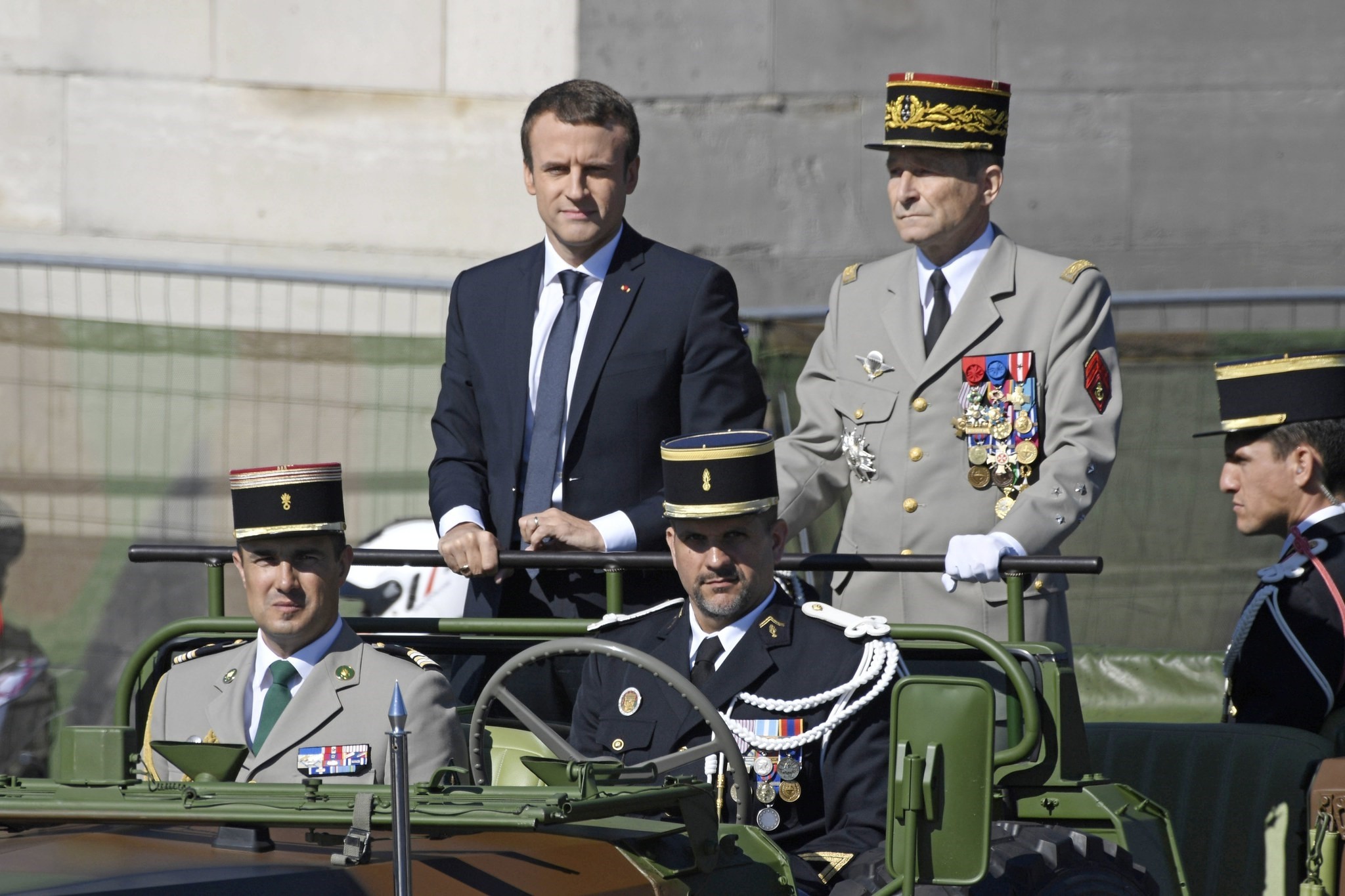 French President Emmanuel Macron (C) and Chief of the Defence Staff, French Army General Pierre de Villiers (R) arrive for the traditional military parade as part of the Bastille Day celebrations in Paris, France (EPA Photo)