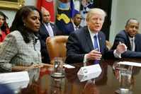 President Donal Trump (C) and White House staffer Omarosa Manigault Newman (L)  during a meeting on African American History Month (AP Photo)