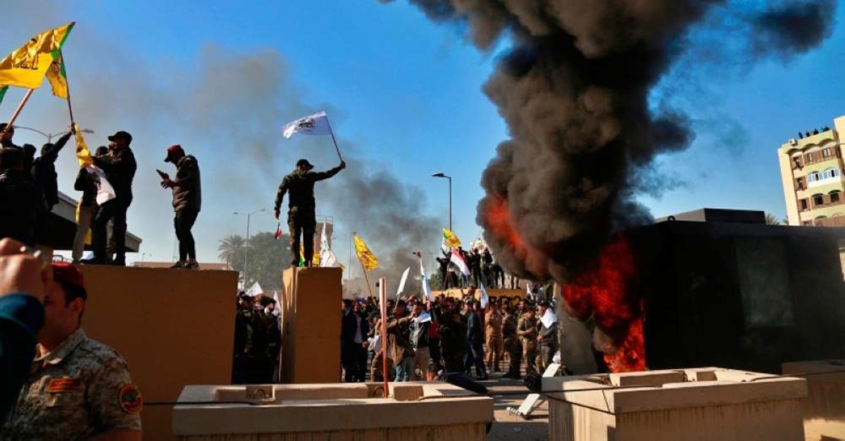 Protesters set fires in front of the U.S. embassy compound, in Baghdad, Iraq, Tuesday, Dec. 31, 2019. (AP Photo)