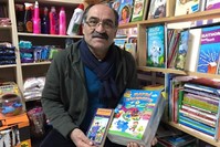 Kamber Bozan poses with books in his grocery store, Istanbul, Jan. 8, 2020. (?HA Photo) 