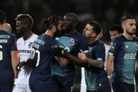 Porto's Sergio Oliveira, center left, and Otavio, center right, talk with teammate Moussa Marega, center, as he tries leaves the pitch after hearing monkey chants, Guimares, Portugal, Feb. 16, 2020. (AP Photo)