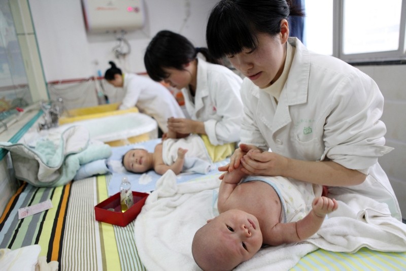 This file picture taken on December 15, 2016, shows nurses massaging babies at an infant care centre in Yongquan, Chongqing municipality, in southwest China (AFP Photo)