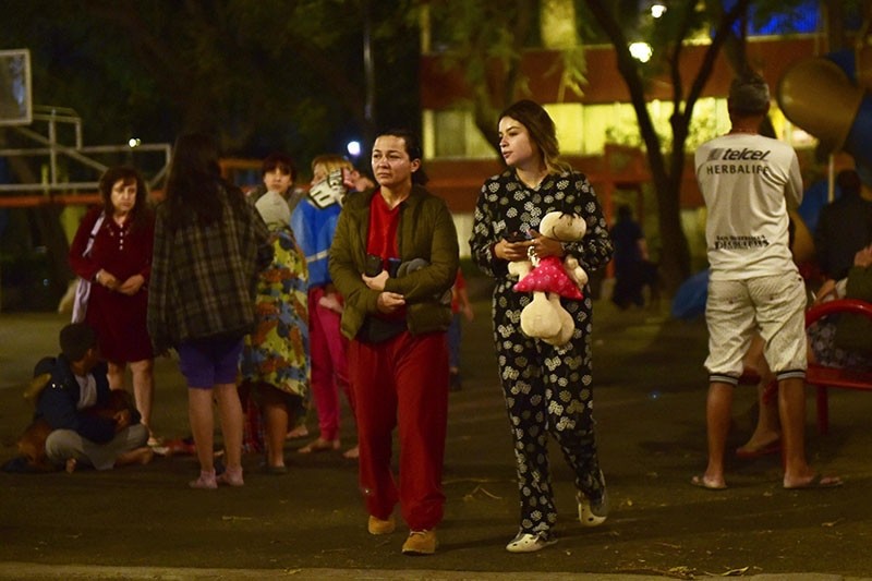Residents stand out in the street following a 5.9 magnitude quake in Mexico City early on Feb. 19, 2018. (AFP Photo)