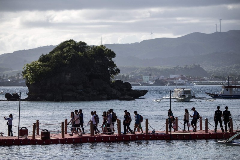 Tourists arrive at the Philippine island of Boracay on October 26, 2018. (AFP Photo)