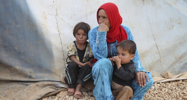 Syrian refugees from Raqqa rest near their tents in the Bekaa valley, Lebanon October 19, 2015. (Reuters Photo)