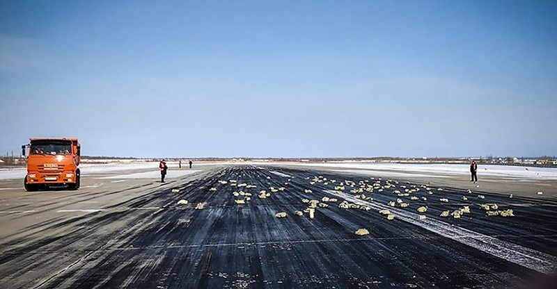 A handout picture provided by YakutiaMedia news agency shows precious metal ingots on the runway of the airport of Yakutsk, Russia, March 15, 2018. (AFP Photo/YakutiaMedia)