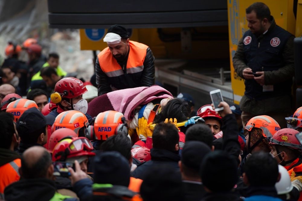 Rescue crews evacuate Havva Tekgu00f6z from the rubble some 19 hours after the collapse in Istanbul's Kartal district on Feb. 7, 2019. 