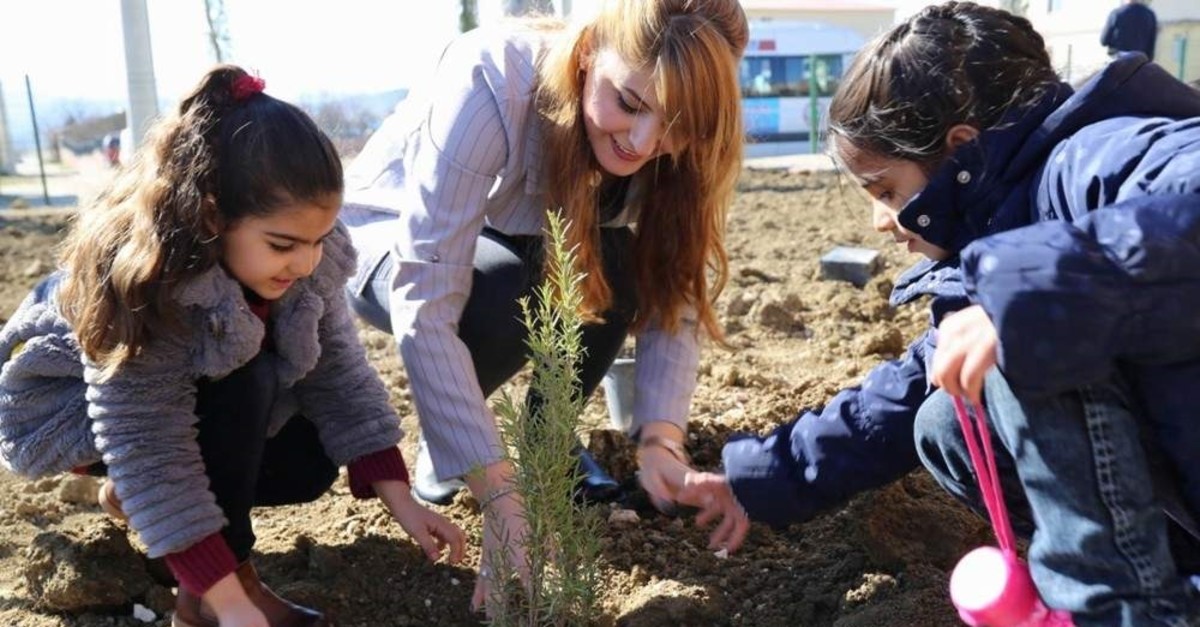 Students plant a sapling with their teacher in this undated photo, Diyarbak?r, Turkey. (IHA Photo)