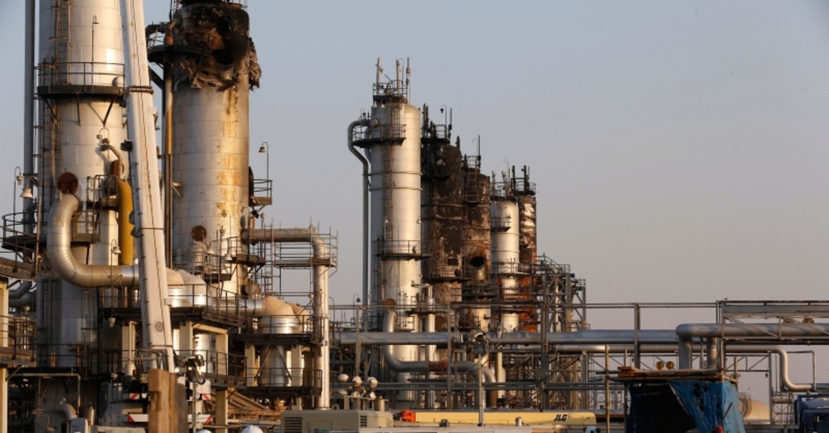 During a trip organized by Saudi information ministry, workers fix the damage in Aramco's oil processing facility after the recent Sept. 14 attack in Abqaiq, near Dammam in the Kingdom's Eastern Province, Friday, Sept. 20, 2019. (AP Photo)