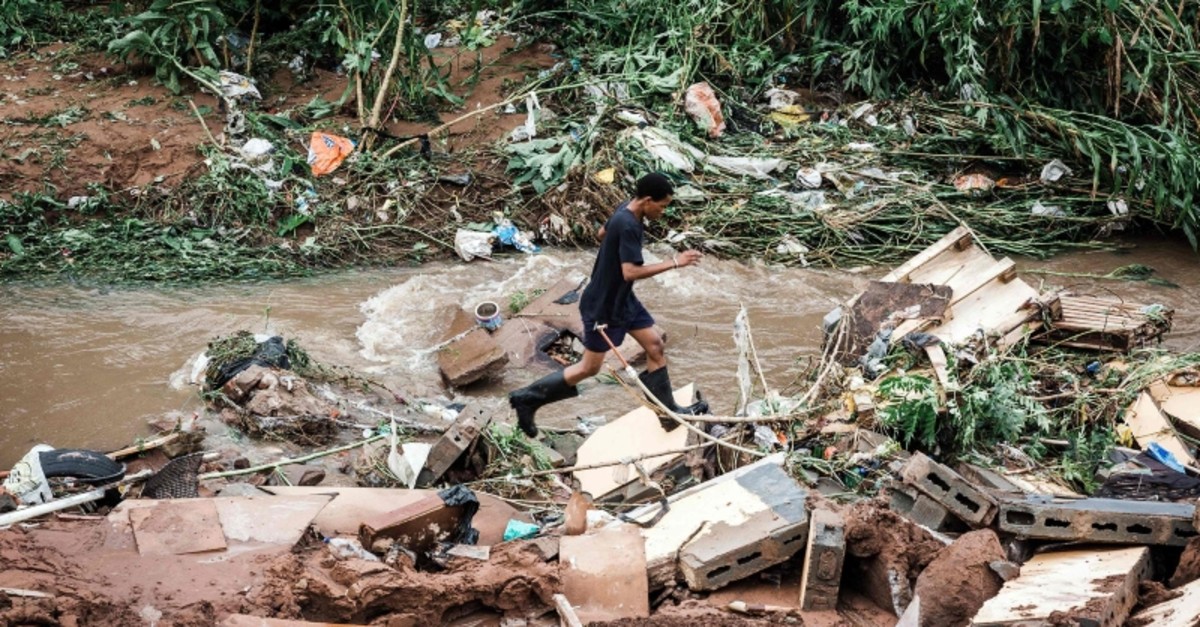A man tries to retrieve some of his furniture at an informal settlement of BottleBrush, south of Durban, after torrential rains and flash floods destroyed his home on April 23, 2019. (AFP Photo)