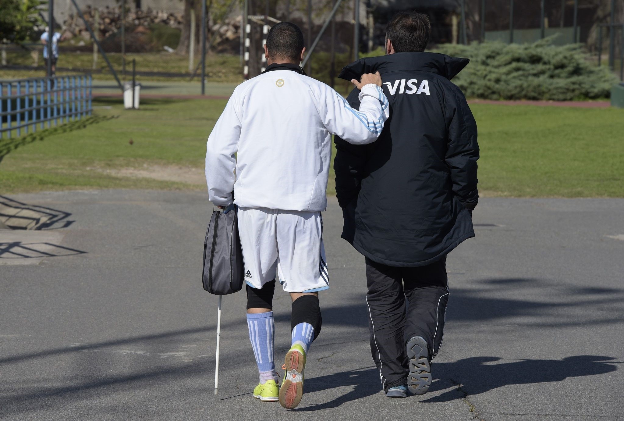 Argentine paralympic blind football forward Silvio Velo (L) walks assited by Boca Juniors blind football coach Mariano Arnal before a training session in Buenos Aires on May 19, 2016, ahead of the Rio 2016 Paralympic Games. (AFP Photo)