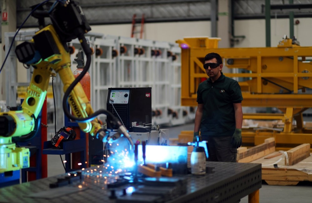 An employee stands as he operates a machine at industrial manufacturing company Gottert in Garin, on the outskirts of Buenos Aires, Argentina, Nov. 1, 2018.