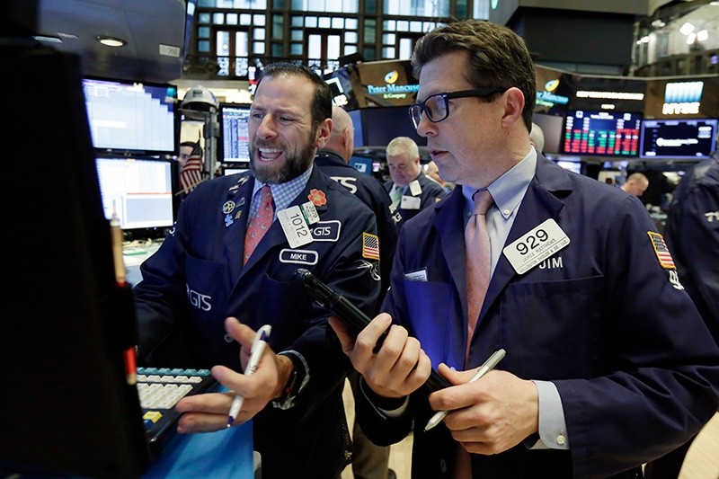 Specialist Michael Pistillo, left, and trader James Matthews work on the floor of the New York Stock Exchange (AP Photo)