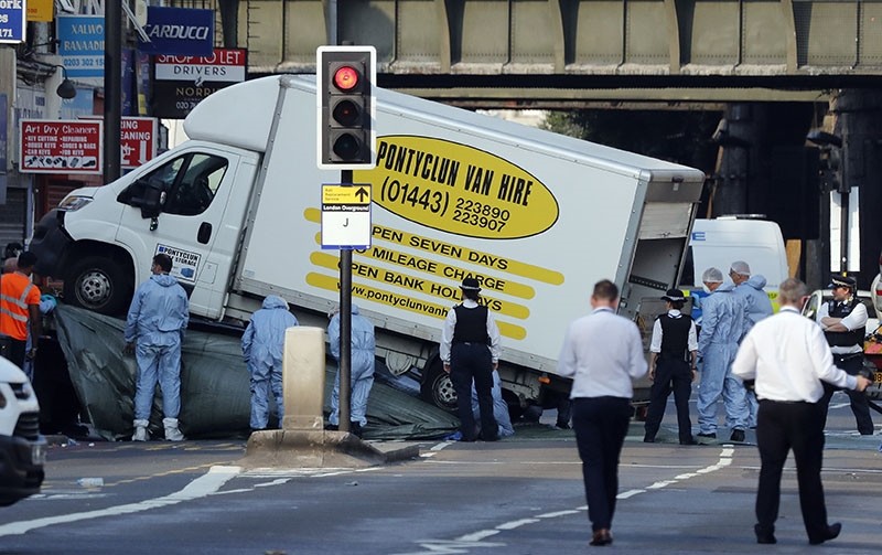 Forensic officers move the van at Finsbury Park in north London, where a vehicle struck pedestrians in north London Monday, June 19, 2017. The vehicle struck pedestrians near a mosque in north London early Monday morning. (AP Photo)
