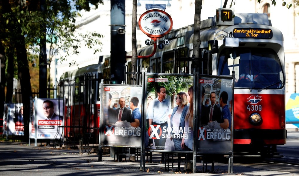A tram passes an election campaign posters of top candidates from Austrian political parties ahead of the general elections, Vienna, Austria, Oct. 5.