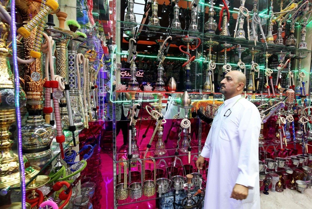 A man inspects water pipes at a shop in Kuwait City. The United Arab Emirates yesterday doubled the price of tobacco and increased soft drink prices by 50 percent, ahead of a more general tax on goods and services on Jan. 1 next year.
