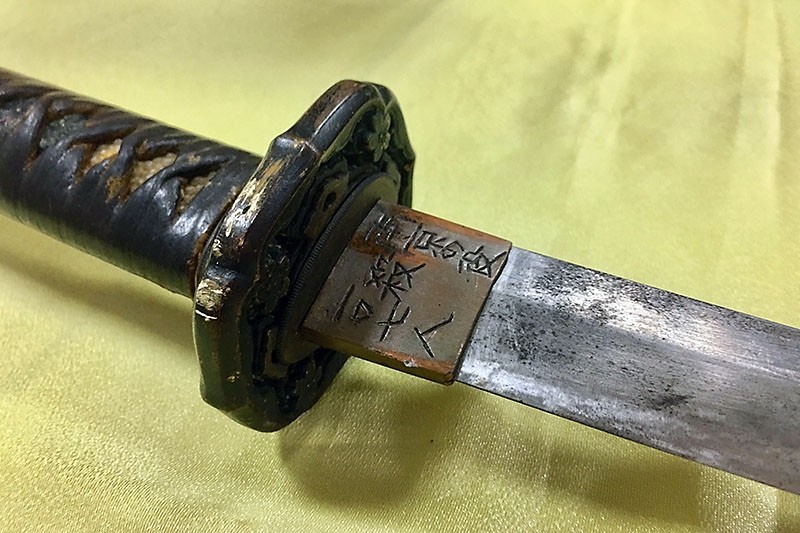This photograph shows a Japanese samurai sword with Chinese script that reads ,killed 107 people during the war in Nanjing, (China),, used August 18 by an attacker that slashed a military police guard at the Presidential Palace in Taipei. (AFP Photo)
