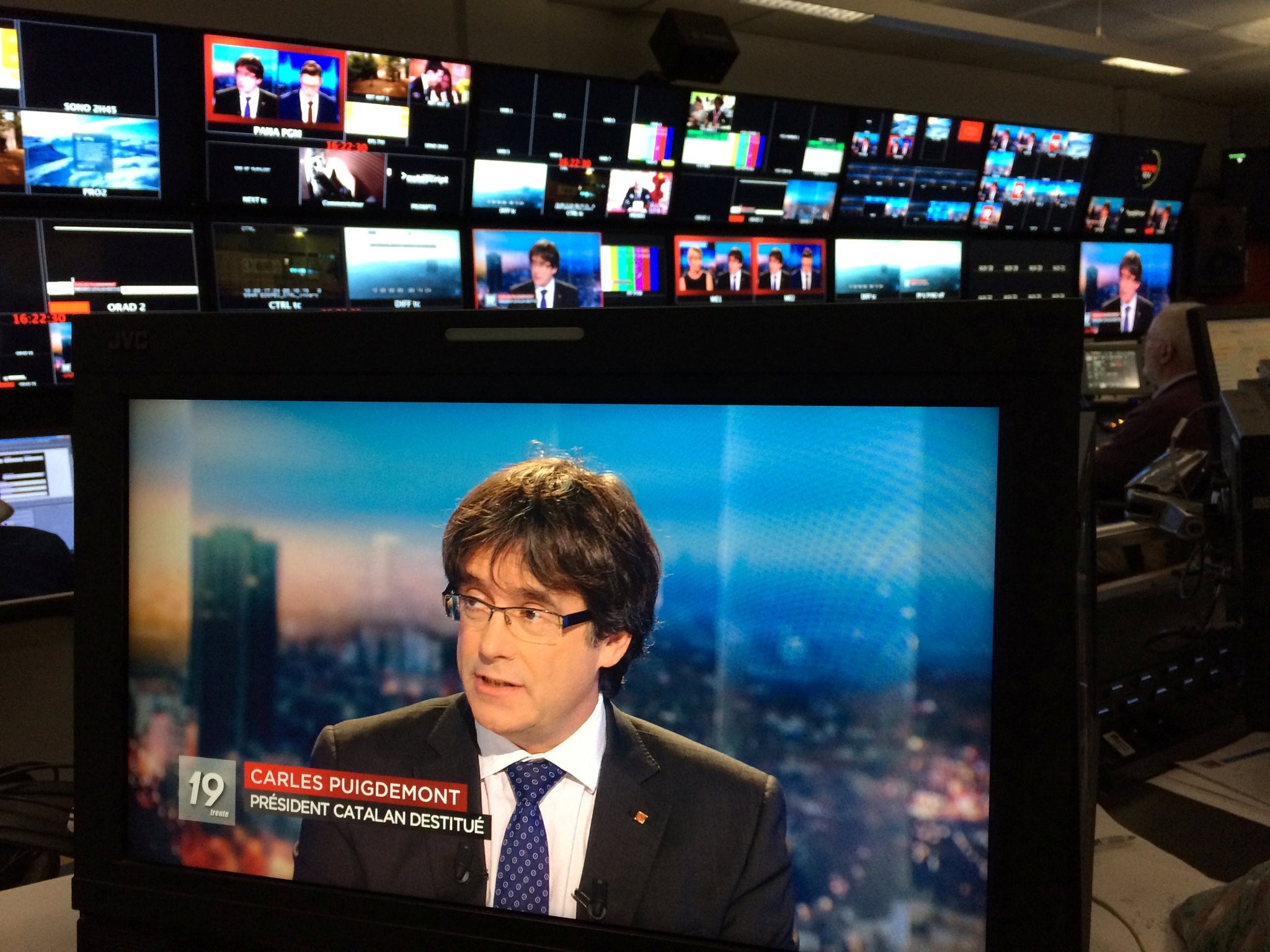 Ousted Catalan President Carles Puigdemont, who fled Belgium following the detention of eight Catalan ministers, appears on a monitor during a live TV interview on a screen in a bar in Brussels, Nov. 3. 