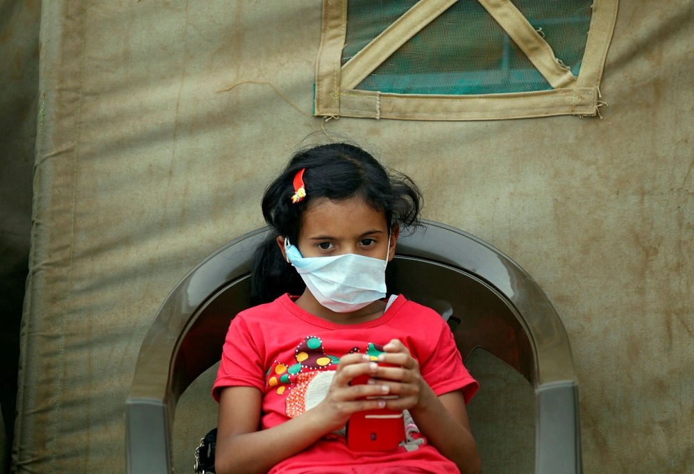 A Yemeni child suspected of being infected with cholera sits outside a makeshift hospital in Sanaa on June 5.