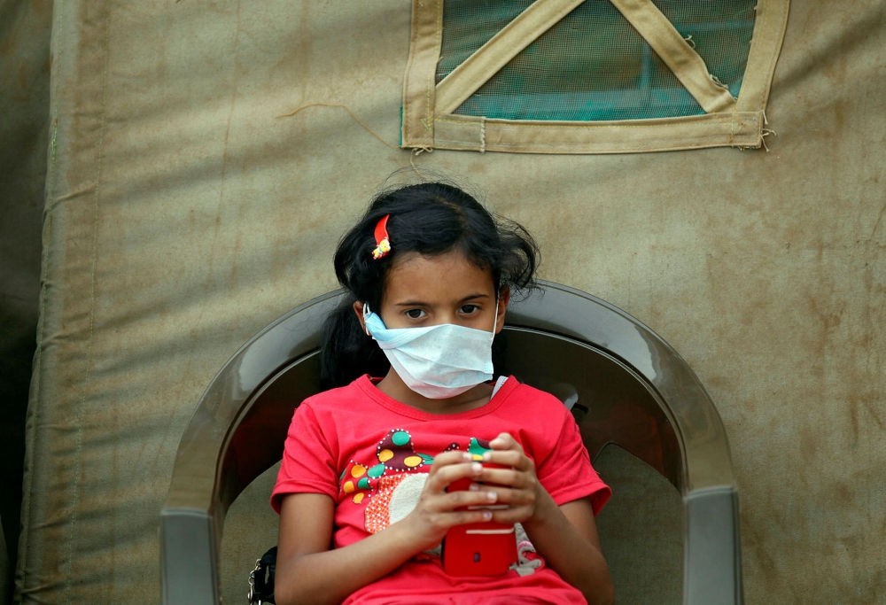 A Yemeni child suspected of being infected with cholera sits outside a makeshift hospital in Sanaa on June 5.