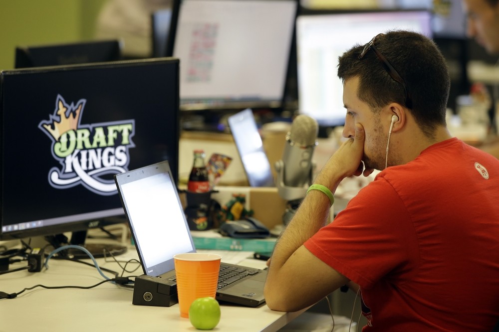 Devlin Du2019Zmura, a tending news manager at DraftKings, a daily fantasy sports company, works on his laptop at the companyu2019s offices in Boston.