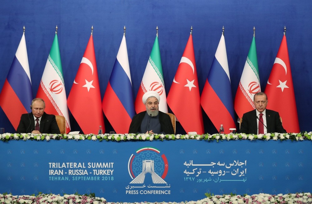 Iranian President Hassan Rouhani (C), President Recep Tayyip Erdou011fan (R) and Russian President Vladimir Putin (L) attend a press conference after their meeting in Tehran, Sept. 7.