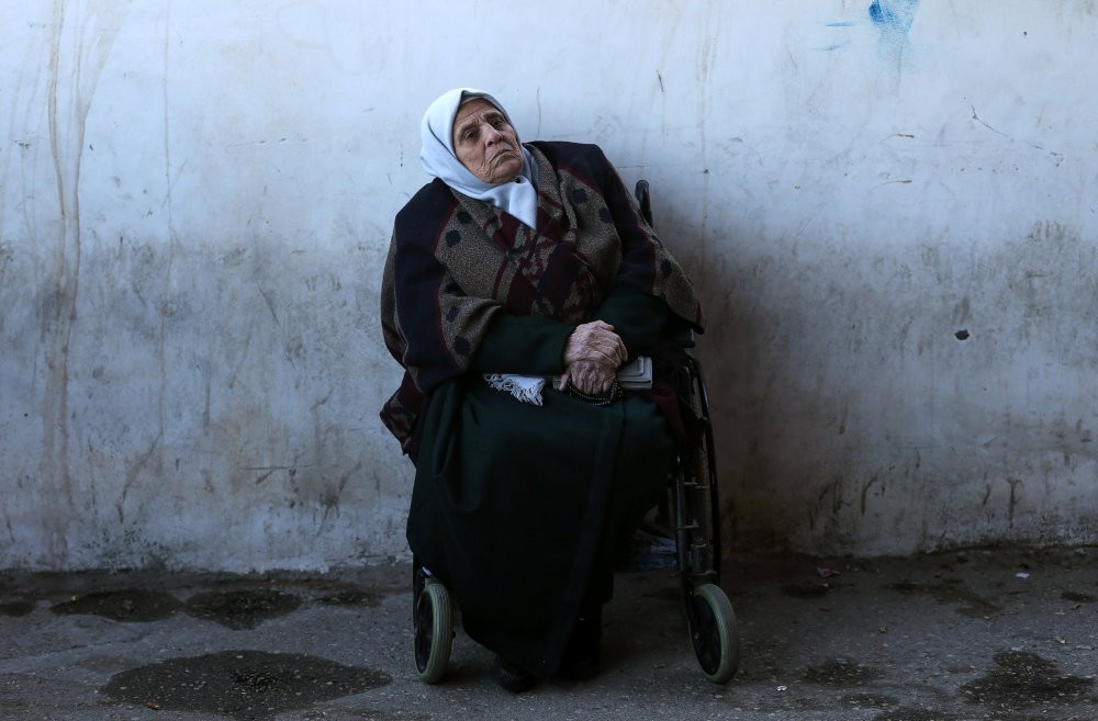 A wheelchair using Palestinian woman waits for a travel permit to leave Gaza through the Rafah border crossing with Egypt, Feb. 3, 2019.