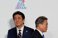 South Korean President Moon Jae-In is welcomed by Japanese PM Shinzo Abe upon his arrival for a welcome and family photo session at the G20 leaders summit in Osaka, Japan, June 28, 2019. (Reuters Photo)