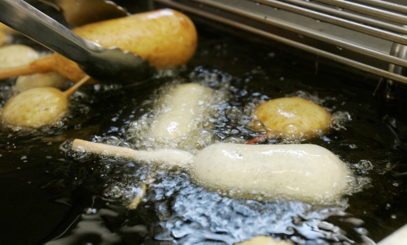 In this Wednesday, Aug. 8, 2007 file photo, a Milky-Way candy bar is deep-fried in oil free of trans fats at a food booth at the Indiana State Fair in Indianapolis. Indiana was the first US state to require the switch at its state fair. (AP Photo)