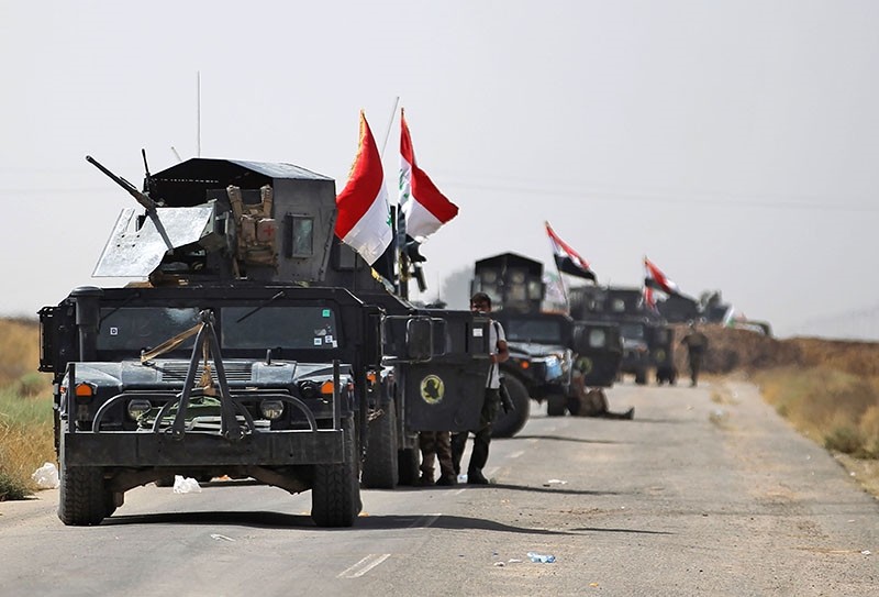Vehicles of the Iraqi forces and Hashd al-Shaabi (Popular Mobilisation) paramilitaries are seen on the advance towards the Daesh's stronghold of Hawija on October 3, 2017, to recapture the town from the terrorist group. (AFP Photo)