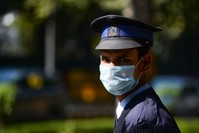 A private security guard wearing a protective face mask amid concerns over the COVID-19 coronavirus outbreak stands an the entrance to a hotel in New Delhi, Feb. 13, 2020. (AFP Photo)
