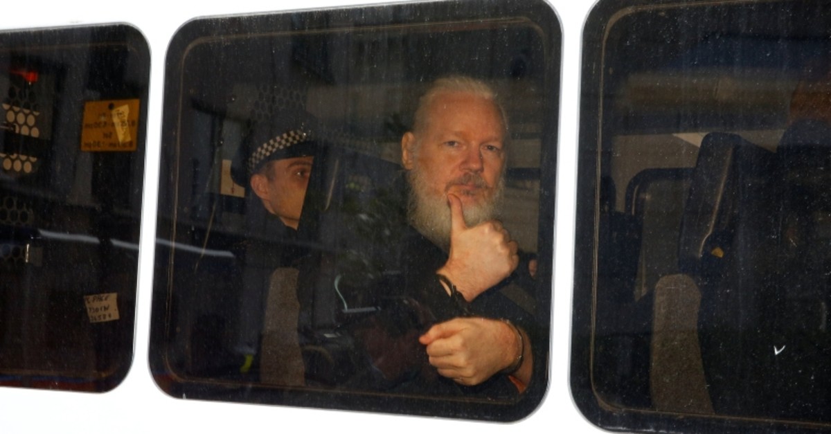WikiLeaks founder Julian Assange is seen in a police van after was arrested by British police outside the Ecuadorian embassy in London, Britain April 11, 2019. (Reuters Photo)