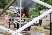 Cartel gunmen are seen near a burning truck during clashes with federal forces following the detention of Ovidio Guzman, son of drug kingpin Joaquin ,El Chapo, Guzman, in Culiacan, Sinaloa state, Mexico Oct. 17, 2019. (REUTERS)