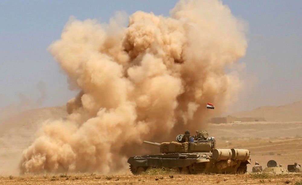Smoke billows as Iraqi government forces advance toward the city of Tal Afar, Aug. 20.