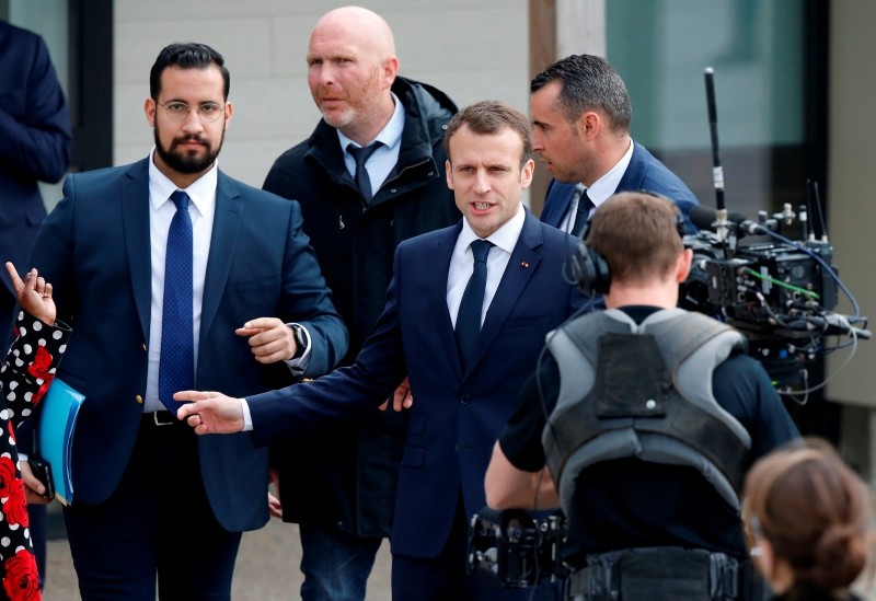 In this file photo taken on April 12, 2018 President Macron (C), next to Elysee Chief Security Officer Alexandre Benalla (L), arrives at a primary school in Berd'huis, northwestern France, for a television interview. (AFP Photo)