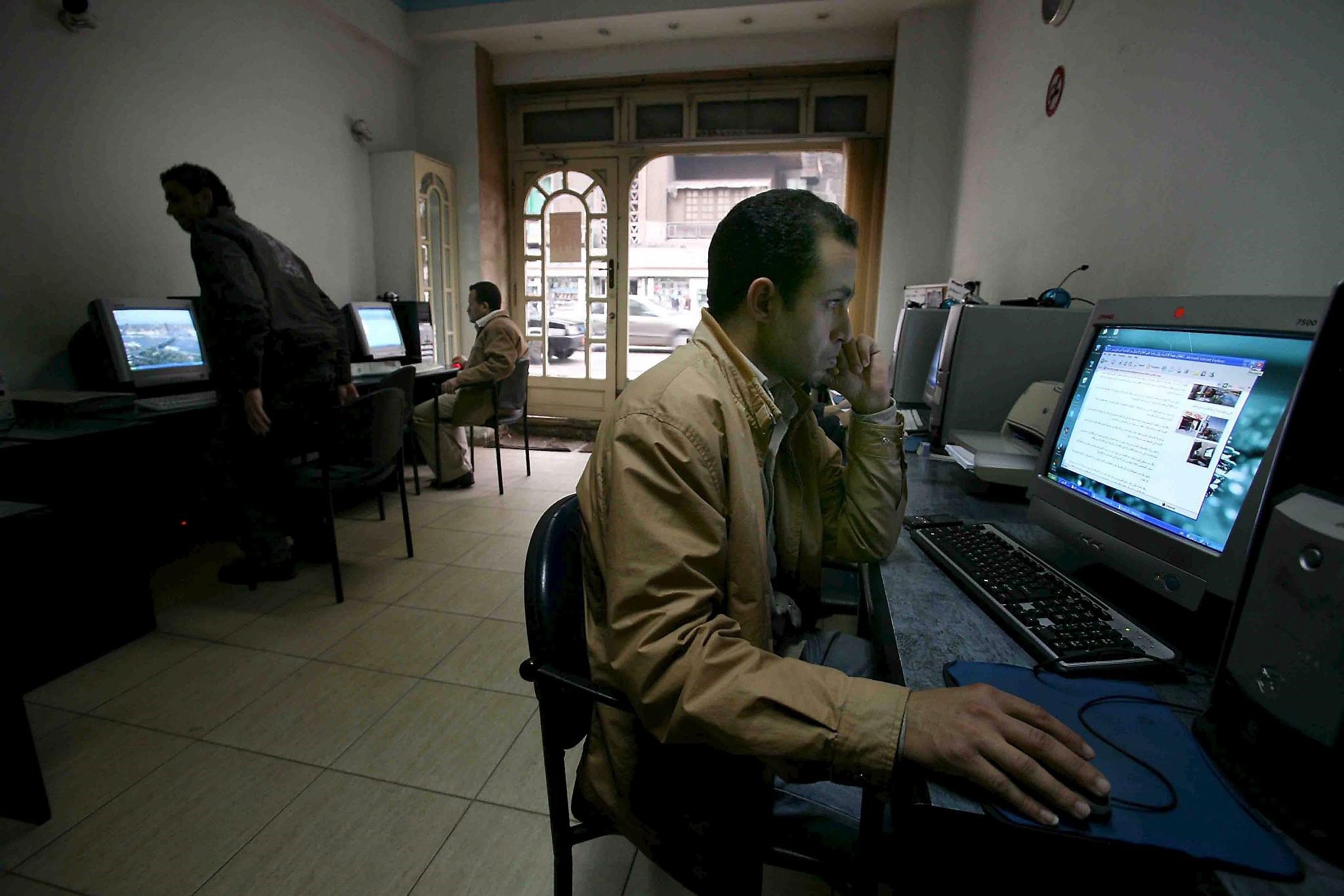 A man looking at a computer screen at an internet cafe in Cairo, Egypt. (EPA Photo)
