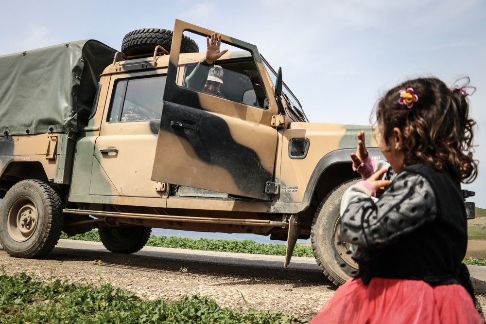 A Syrian refugee child waves at Turkish soldier going to the Syrian border for Operation Olive Branch which aimed to liberate the Syrian city of Afrin from YPG terrorists.